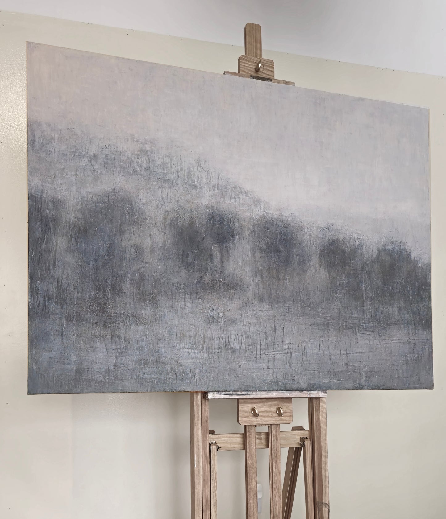 Lobos Valley and Karl's Cloak at Sunset oil painting by Carrie Bergey on an easel, showcasing textured brushwork and atmospheric depth.