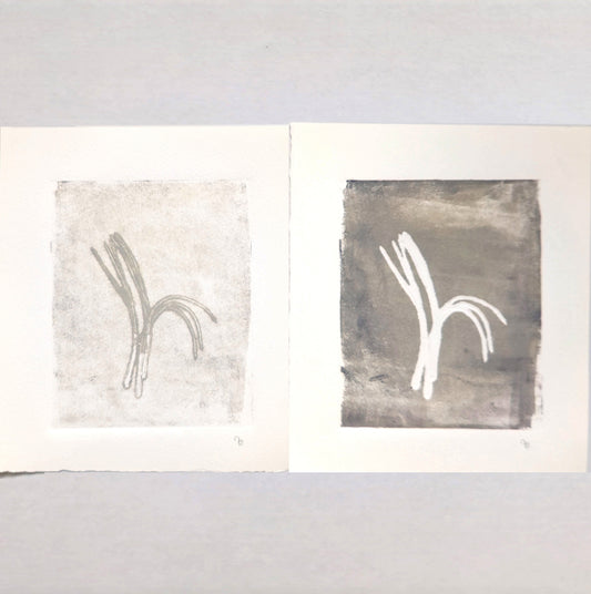 Original Fine Art Monoprint Diptych Collection by Carrie Bergey displayed in white ornate frames above a beige sofa, showcasing pine needle-inspired abstract forms.
